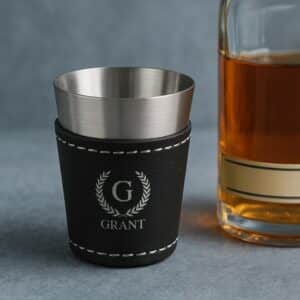 The leather shot glass holds 2oz. and can be customized with each groomsman's monogram.