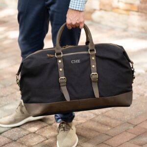 Reinforced leather carrying handles on the black Langston duffle bag
