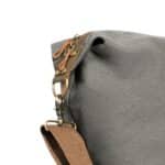 The Langston bag features genuine leather accents and trim with brass hardware