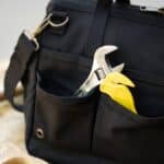 Black tool bag with wrench in pocket