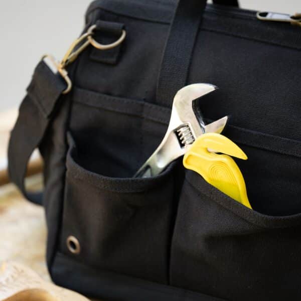 Black tool bag with wrench in pocket