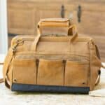 The back of the brown tool bag features three open-top pockets