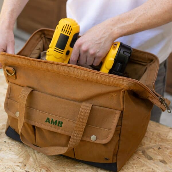 Pulling an electric drill out of the tool bag