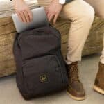 Pulling a laptop out of the black backpack