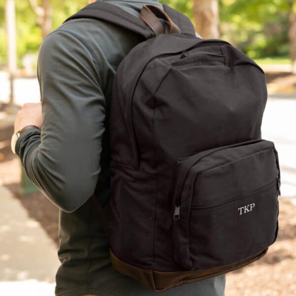 Black backpack embroidered with custom initials
