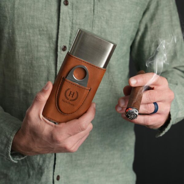 A man smoking a cigar holding his custom monogrammed cigar holder