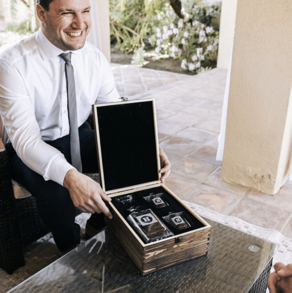 A proud groomsman receiving his custom whiskey decanter set