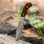 Elk Ridge Fixed Blade Knife stuck in log