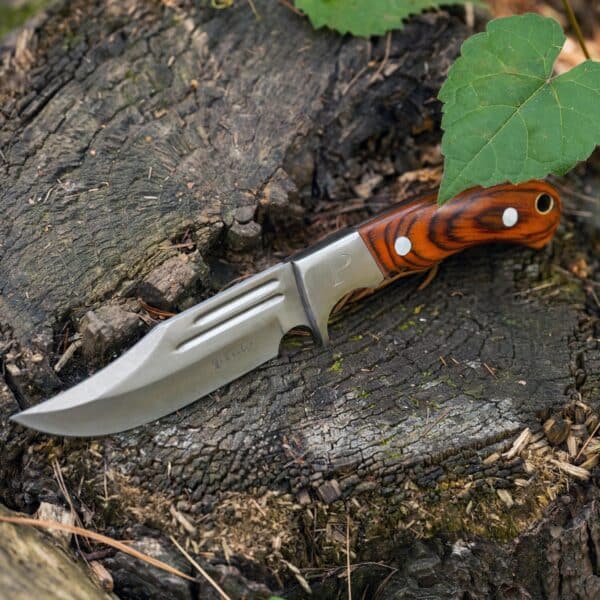 Elk Ridge Fixed Blade Knife shown resting on log