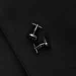 Gunmetal round round cufflinks set against a black suit