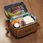 Brown lunchbox shown with a full, chilled lunch inside