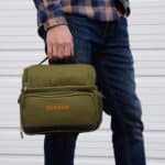 Custom green lunch cooler embroidered with a name in orange thread