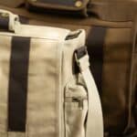 Close-up of buckle and hardware on khaki laptop bag