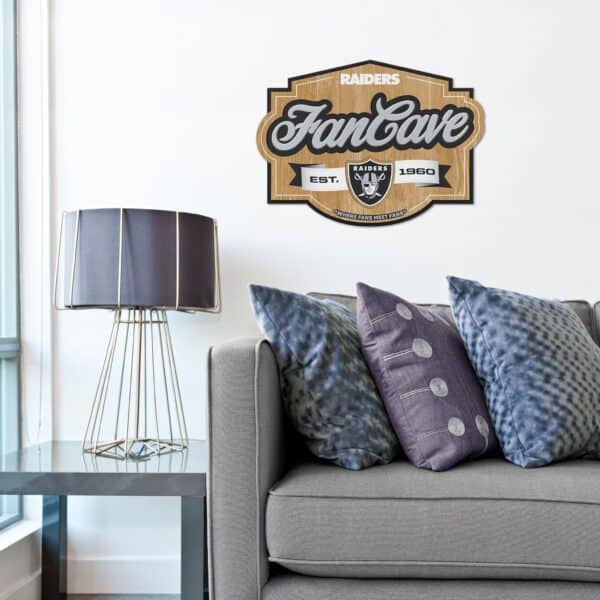 One of our NFL Fan Cave Signs shown hanging in a living room above a couch.