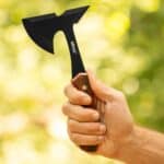 A man prepared to throw his mini axe