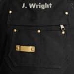 Close-up of personalization area and tape measure bracket on black apron