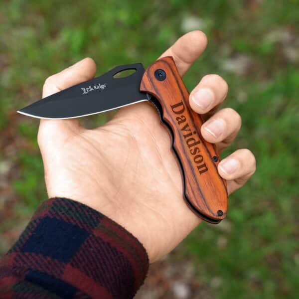 Holding the Elk Ridge Trail Knife with blade opening up.