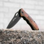 Elk Ridge Trail Knife standing open on a concrete wall
