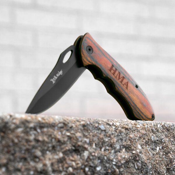 Elk Ridge Trail Knife standing open on a concrete wall
