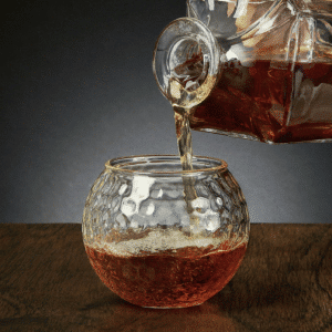 Pour your groomsmen a bourbon in this custom golf ball glass